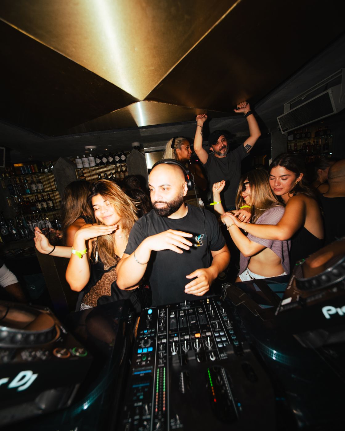 Behind the decks under the gold ceiling at Heist